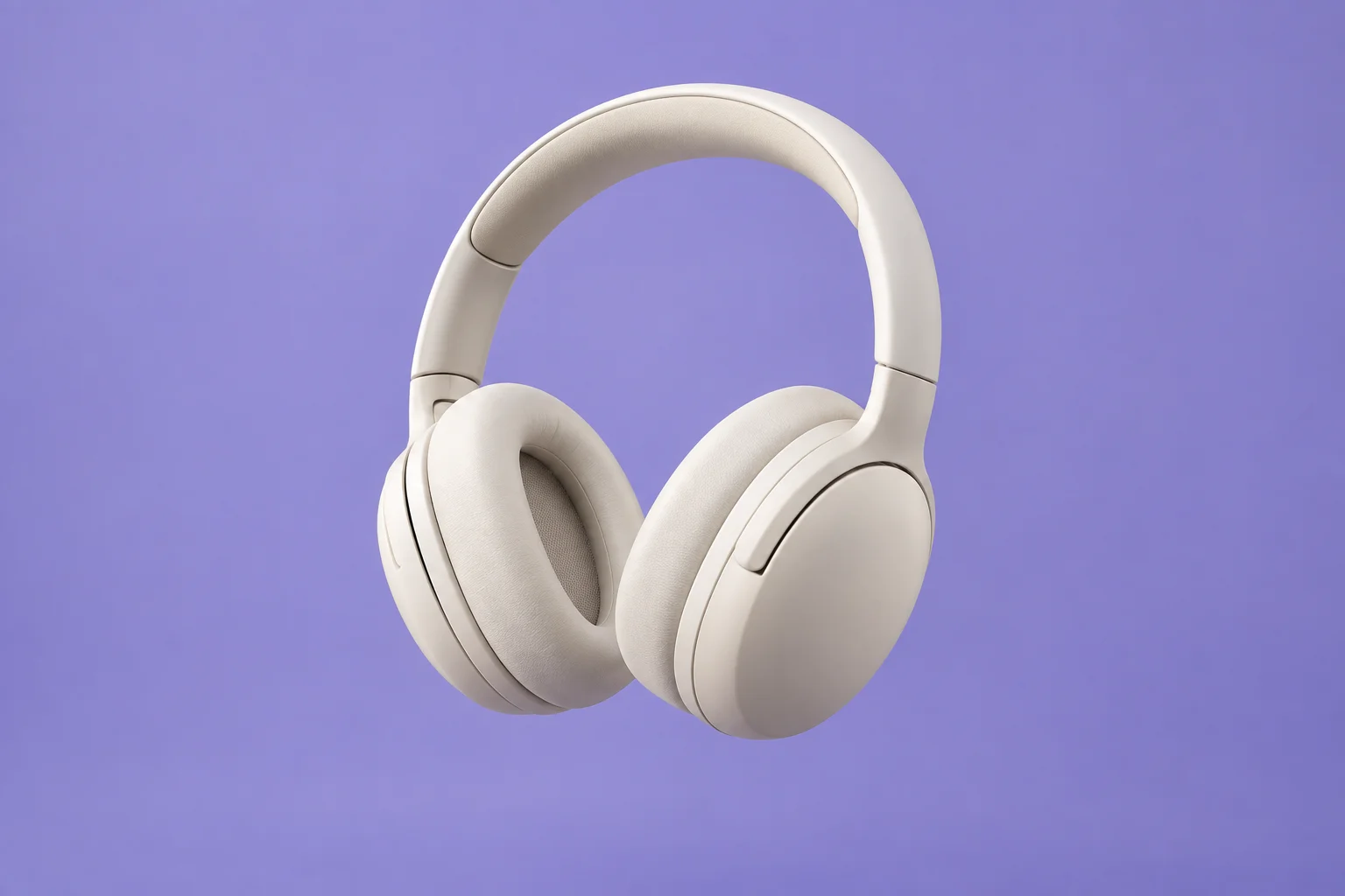 Ivory over-ear headphones against a lilac studio background